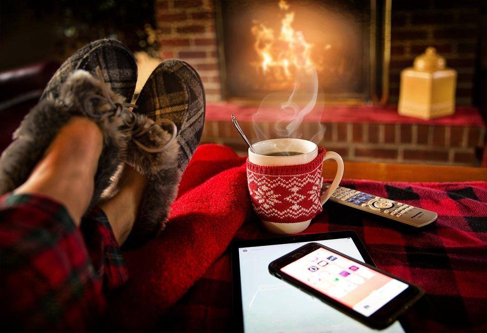 staycation feet up warm drink in front of the fire