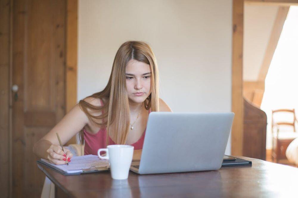 woman staring intently at laptop - an example of improving member engagement metrics