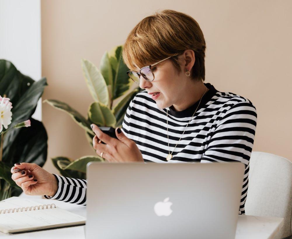 This is what you're up against if you want to prevent multitasking--a woman on her phone while attending your virtual conference