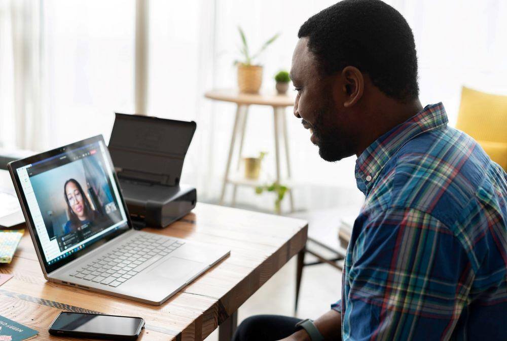 career changers, like this guy getting advice from a woman via his laptop