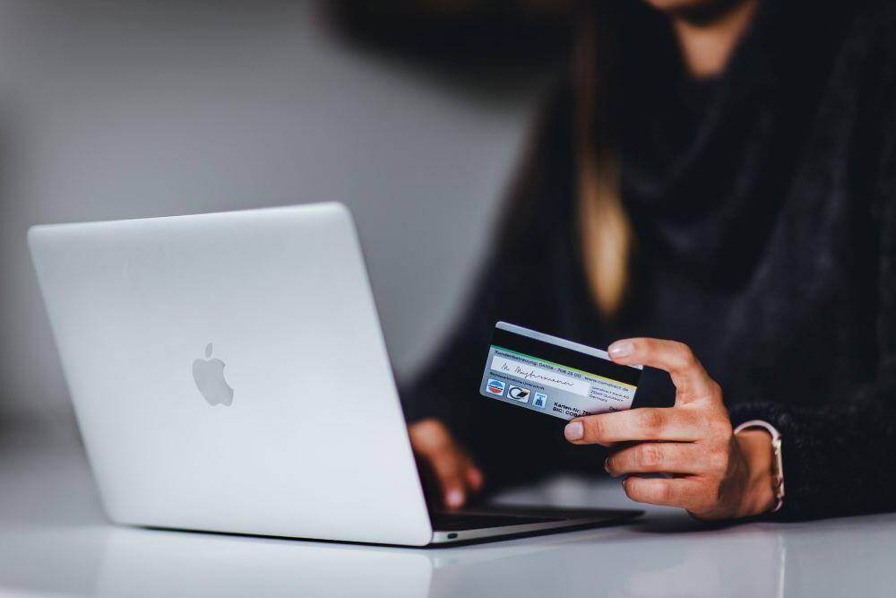 woman with credit card in hand getting ready to donate online to one of the top fundraising nonprofits