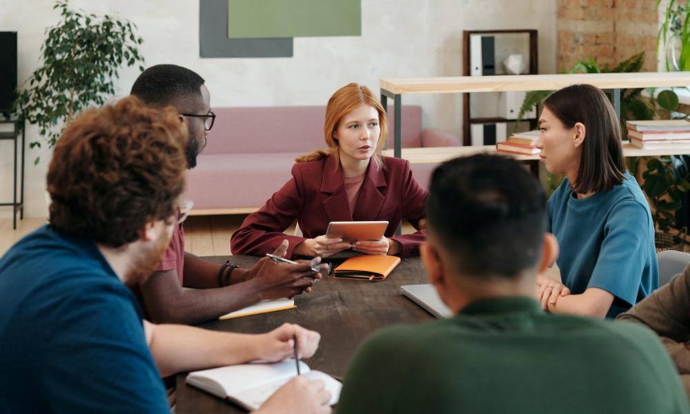 several participants sitting around a table at an Open Space event